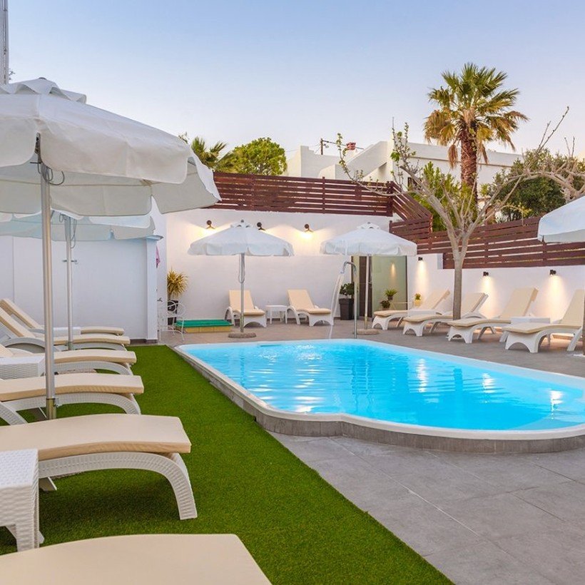 Swimming pool with sun loungers at Spyros Apartments, Kalamaki